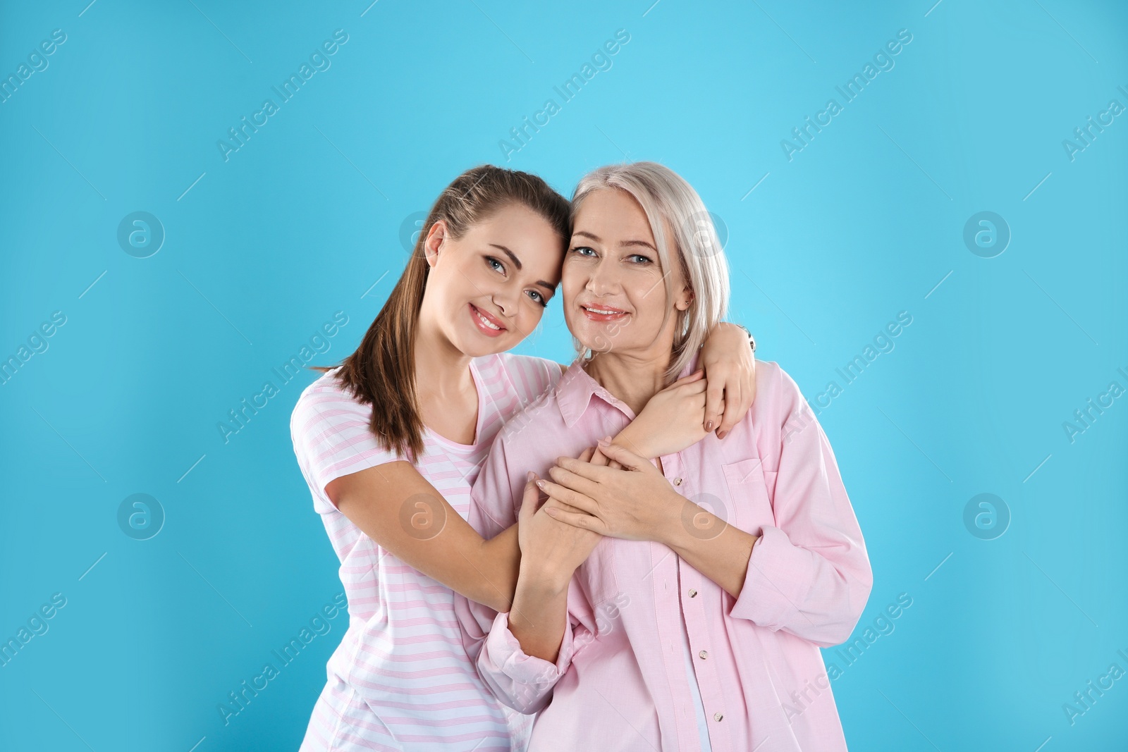 Photo of Portrait of young woman with her mature mother on color background