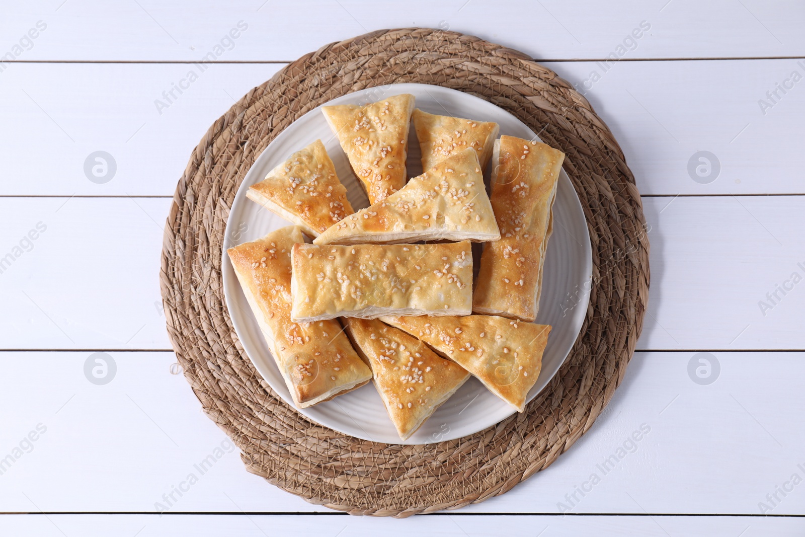 Photo of Delicious puff pastry on white wooden table, top view