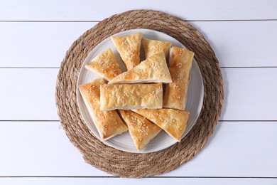 Photo of Delicious puff pastry on white wooden table, top view