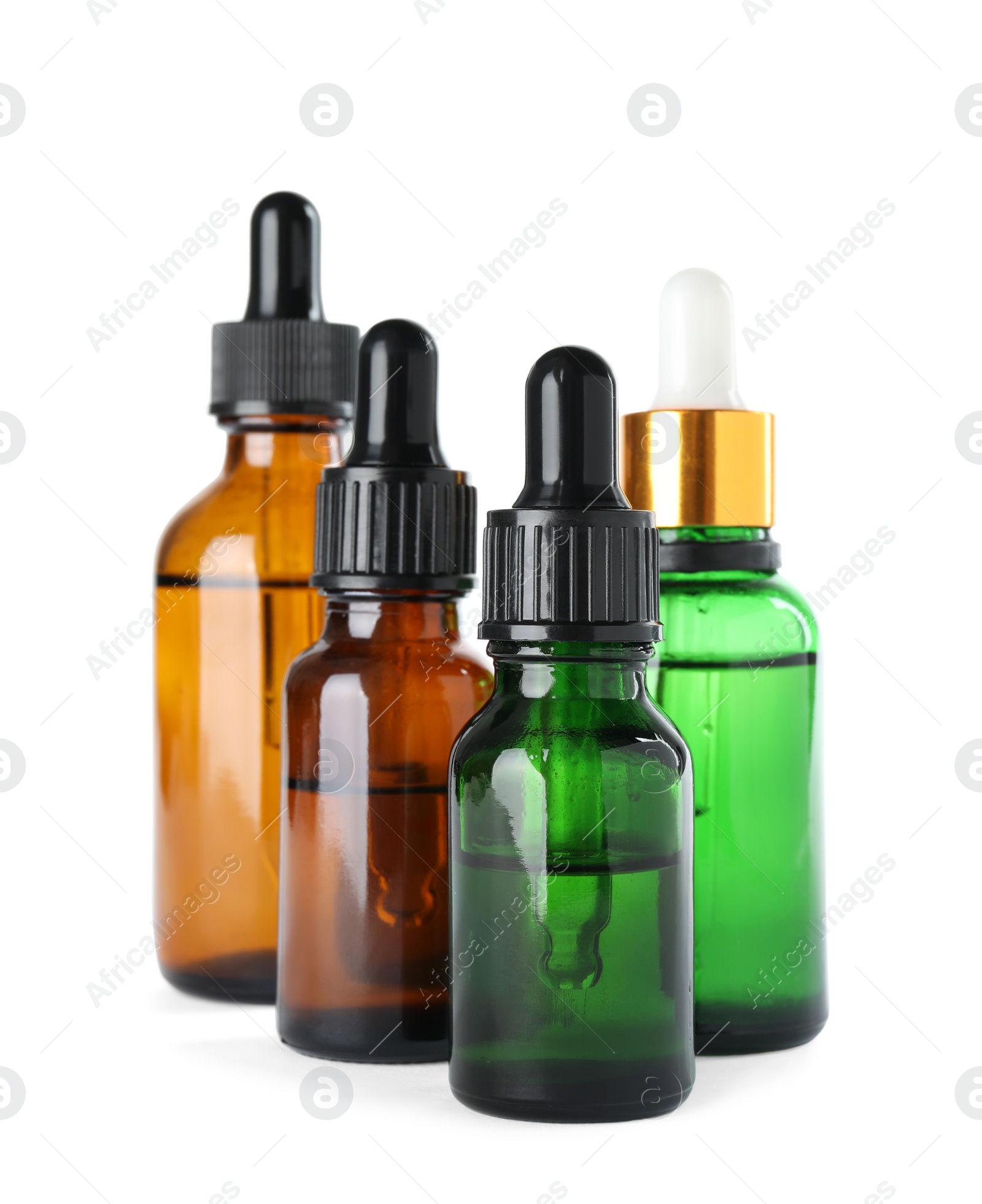 Photo of Bottles of herbal essential oils isolated on white