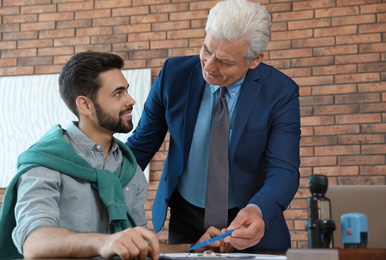 Senior notary working with client in office