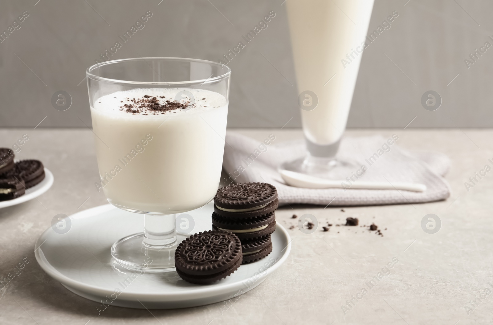 Photo of Glass with milk and chocolate cookies on table against grey background, space for text