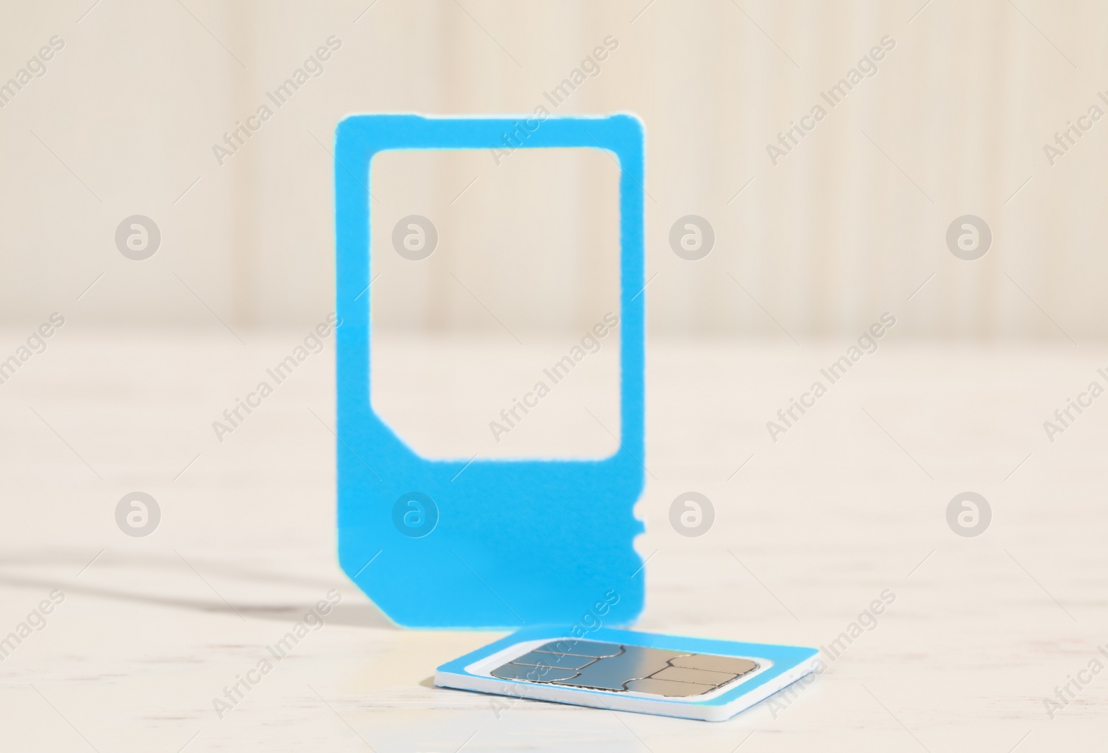 Photo of Multi SIM card on white table, closeup. Space for text