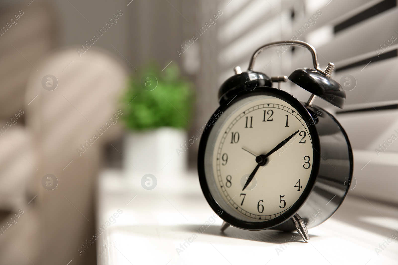 Photo of Alarm clock on windowsill, space for text. Morning time