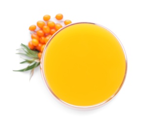 Photo of Delicious sea buckthorn juice and fresh berries isolated on white, top view