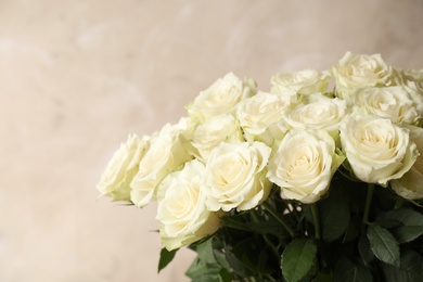 Luxury bouquet of fresh roses on beige background, closeup