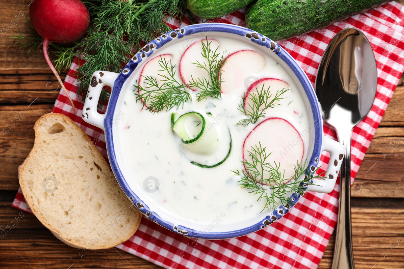 Photo of Delicious cold summer soup on wooden table, flat lay