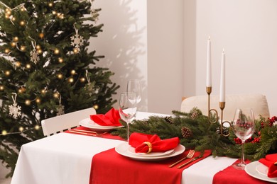 Beautiful table setting with Christmas decor indoors