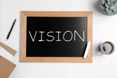 Small chalkboard with word Vision on white background, flat lay