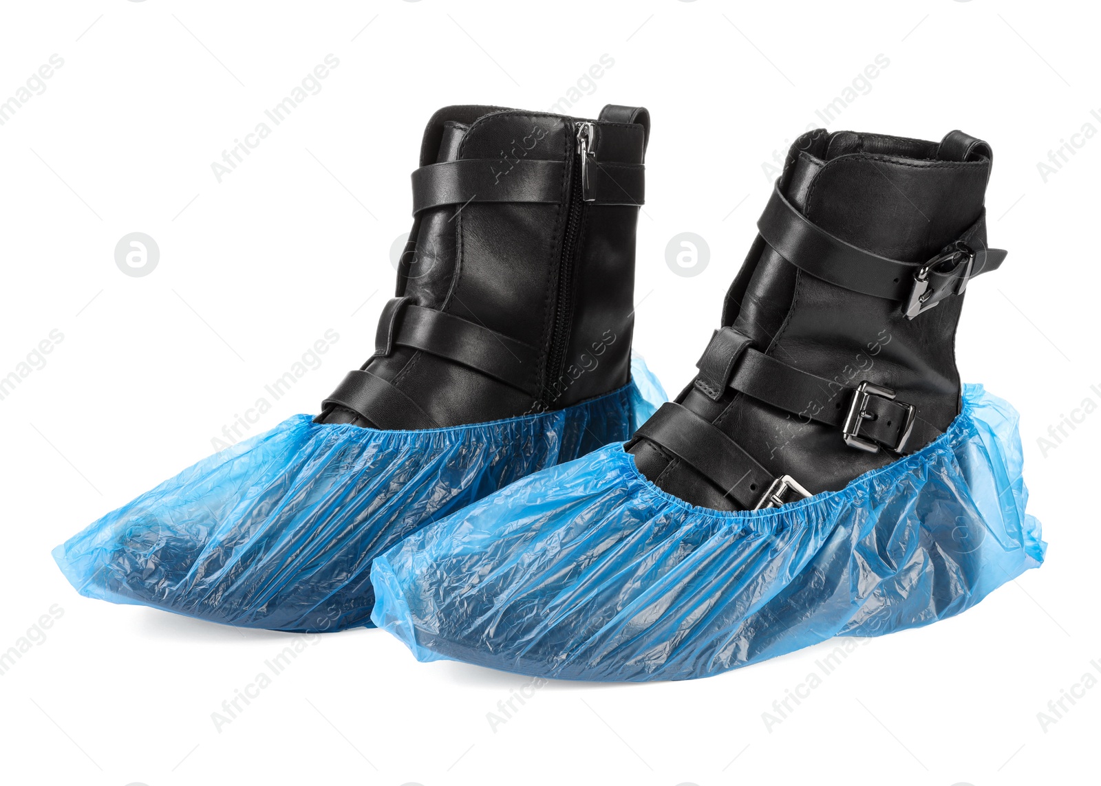 Photo of Women's boots in blue shoe covers isolated on white