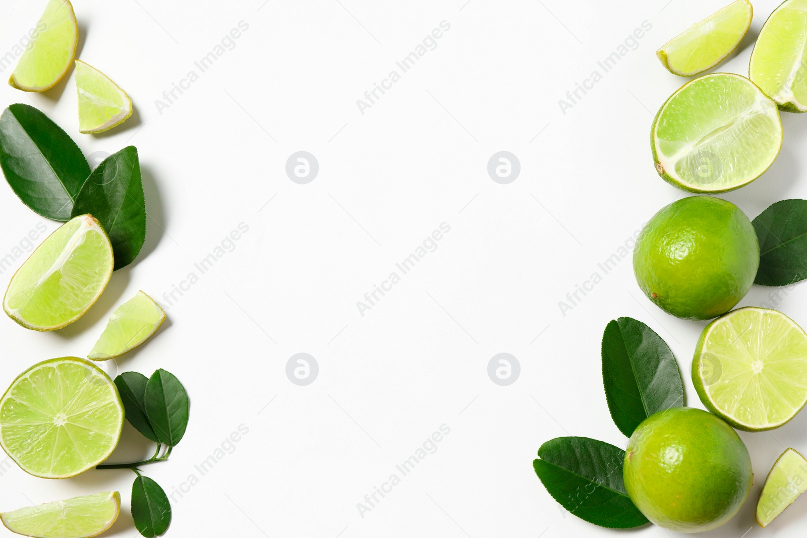 Photo of Fresh ripe limes and leaves on white background, flat lay. Space for text