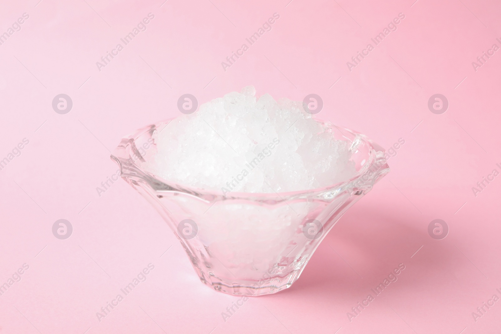 Photo of Shaving ice in glass dessert bowl on pink background, closeup