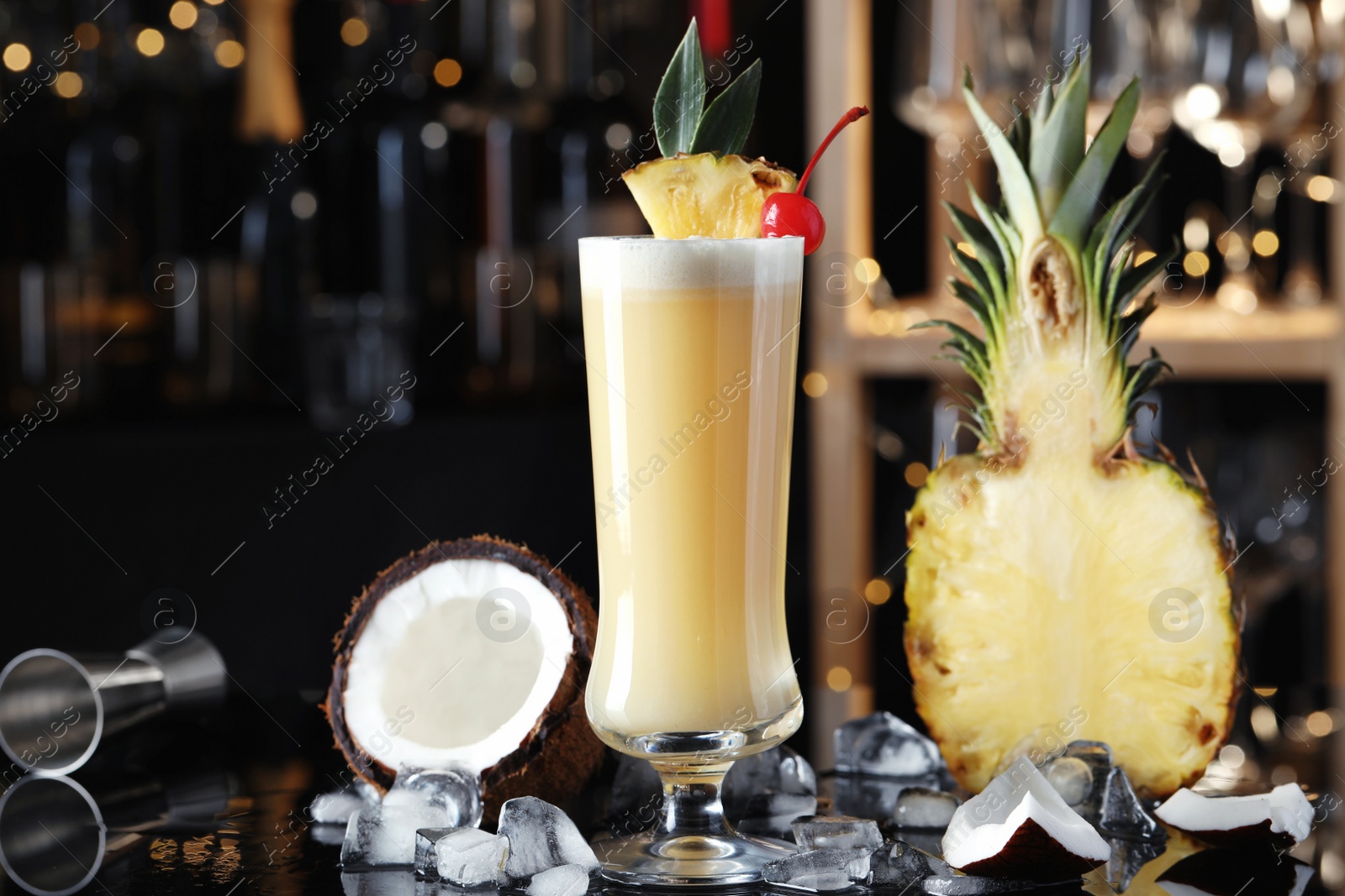 Photo of Tasty Pina Colada cocktail and ingredients on bar countertop