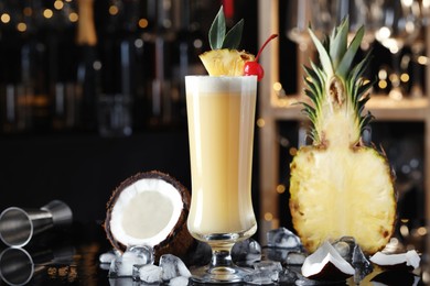 Photo of Tasty Pina Colada cocktail and ingredients on bar countertop