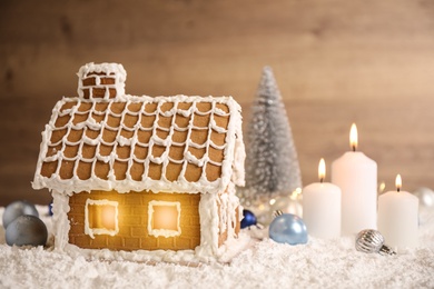 Beautiful gingerbread house and Christmas decor on snow