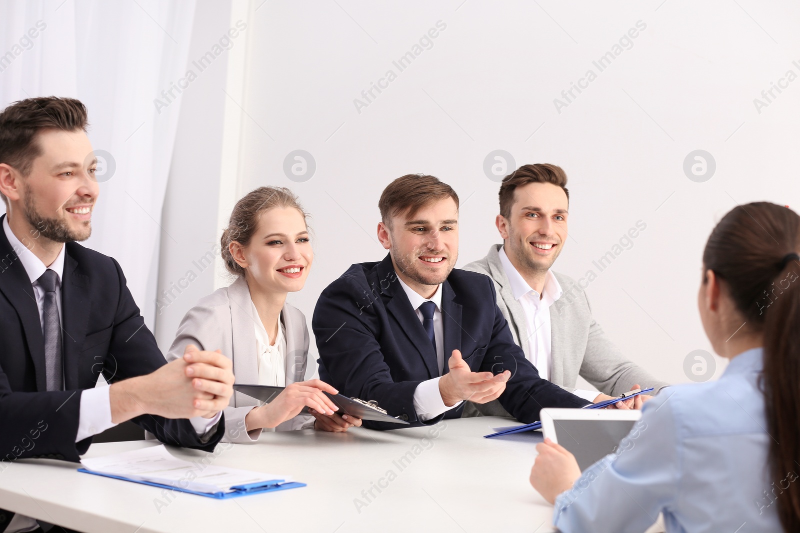 Photo of Human resources commission conducting job interview with applicant, indoors