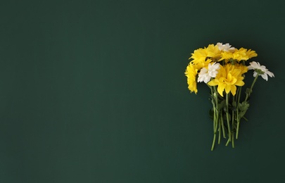 Photo of Beautiful flowers on green chalkboard, flat lay with space for text. Happy Teacher's Day