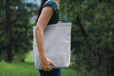 Photo of Woman with eco bag outdoors. Mockup for design