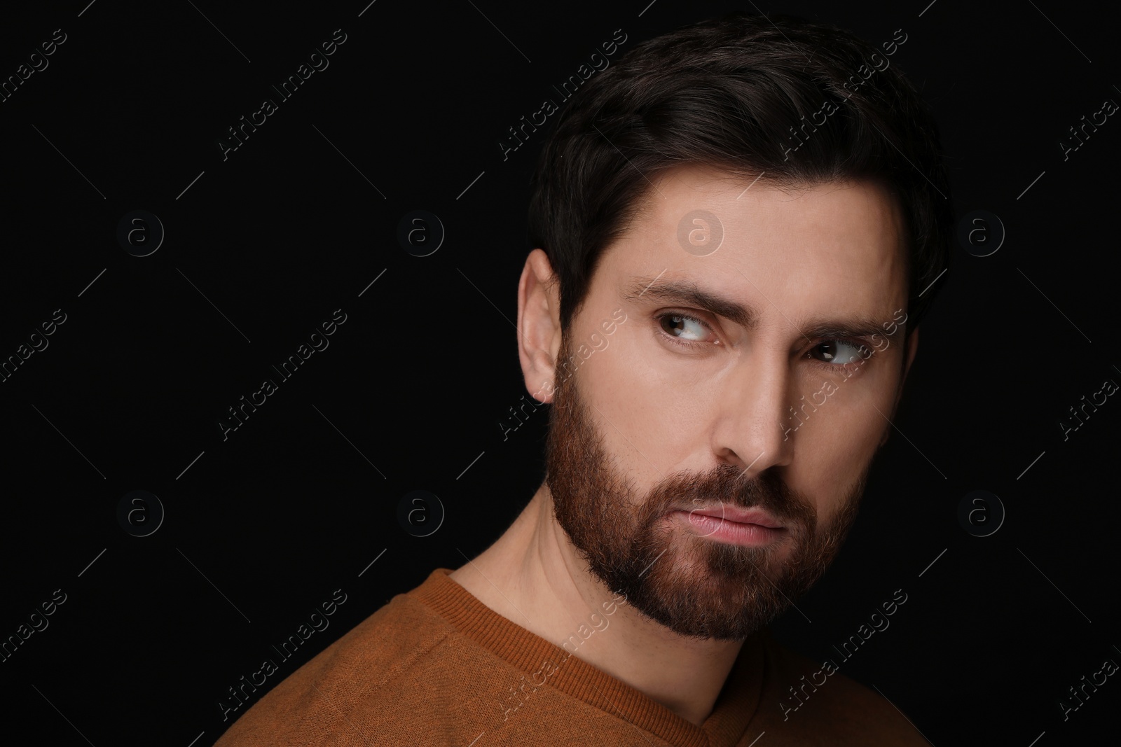 Photo of Evil eye. Man with scary eyes on black background, closeup and space for text