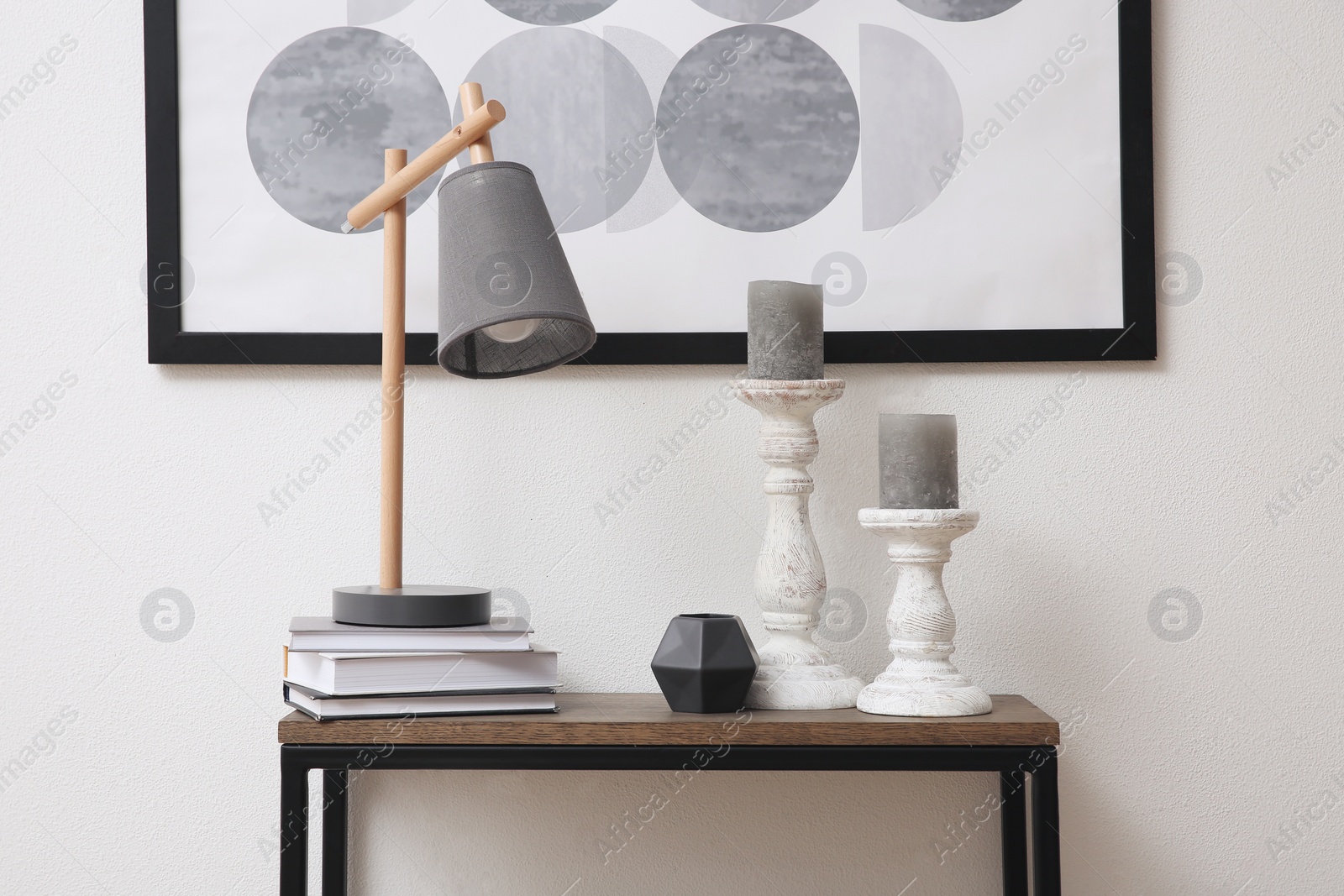 Photo of Hallway with stylish console table and picture. Interior design