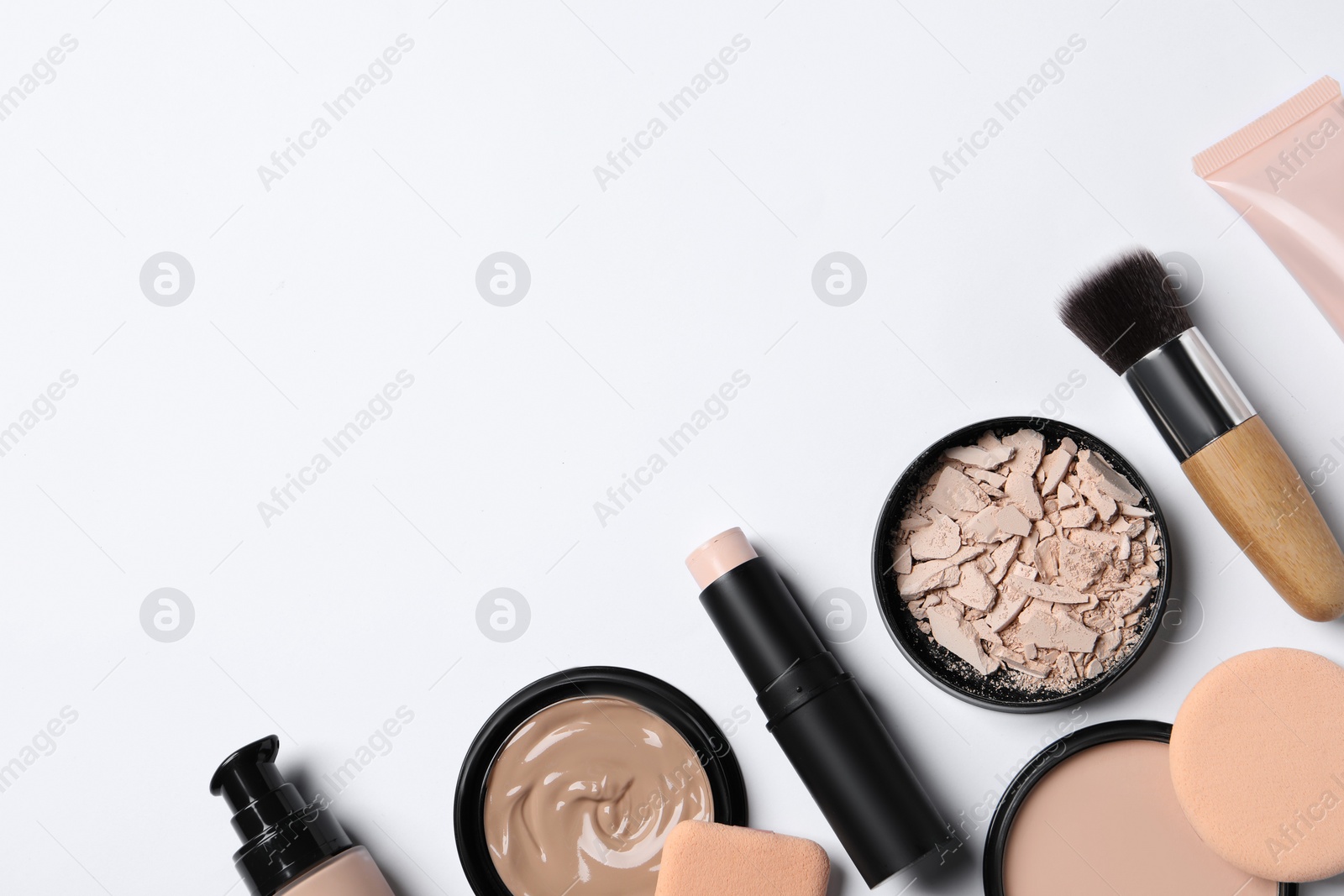 Photo of Foundation, beauty accessories and face powders on white background, flat lay. Space for text