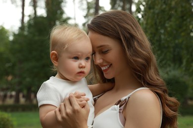 Photo of Mother with her cute baby spending time together outdoors