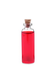 Glass bottle of red food coloring on white background