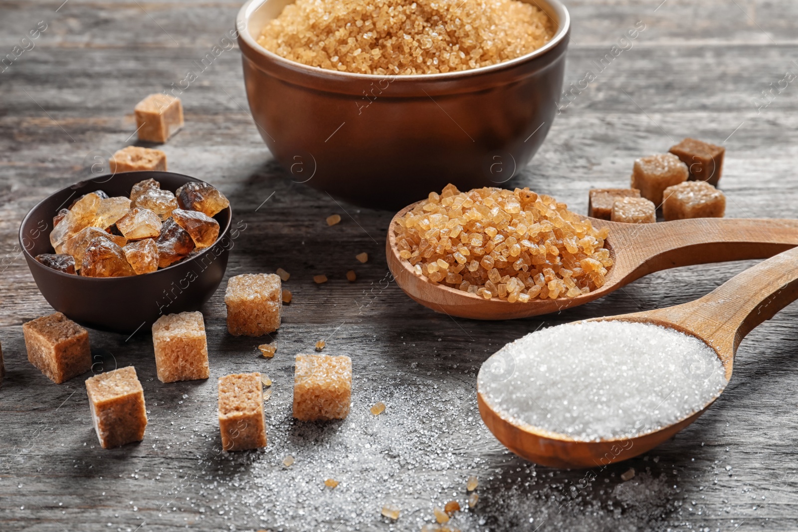 Photo of Composition with different types of sugar on wooden table