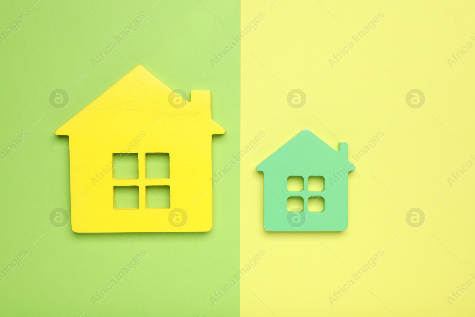 Photo of Small and big house figures on color background, flat lay. Pareto principle concept