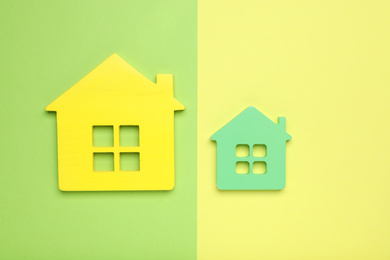 Photo of Small and big house figures on color background, flat lay. Pareto principle concept