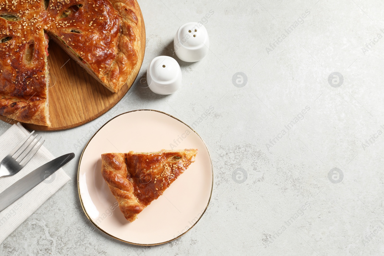 Photo of Tasty homemade pie served on light grey table, flat lay. Space for text