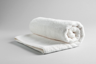 Fresh soft rolled towel on light background