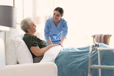 Care worker with elderly woman in geriatric hospice