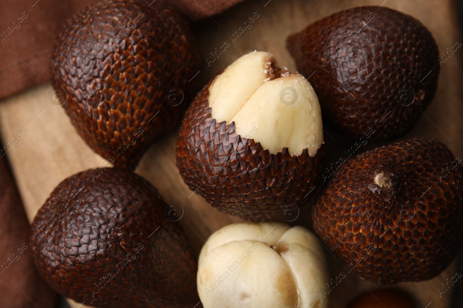 Photo of Fresh salak fruits on wooden board, top view