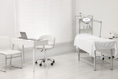 Modern interior of dermatologist's office with examination table