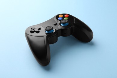 Photo of Wireless game controller on light blue background