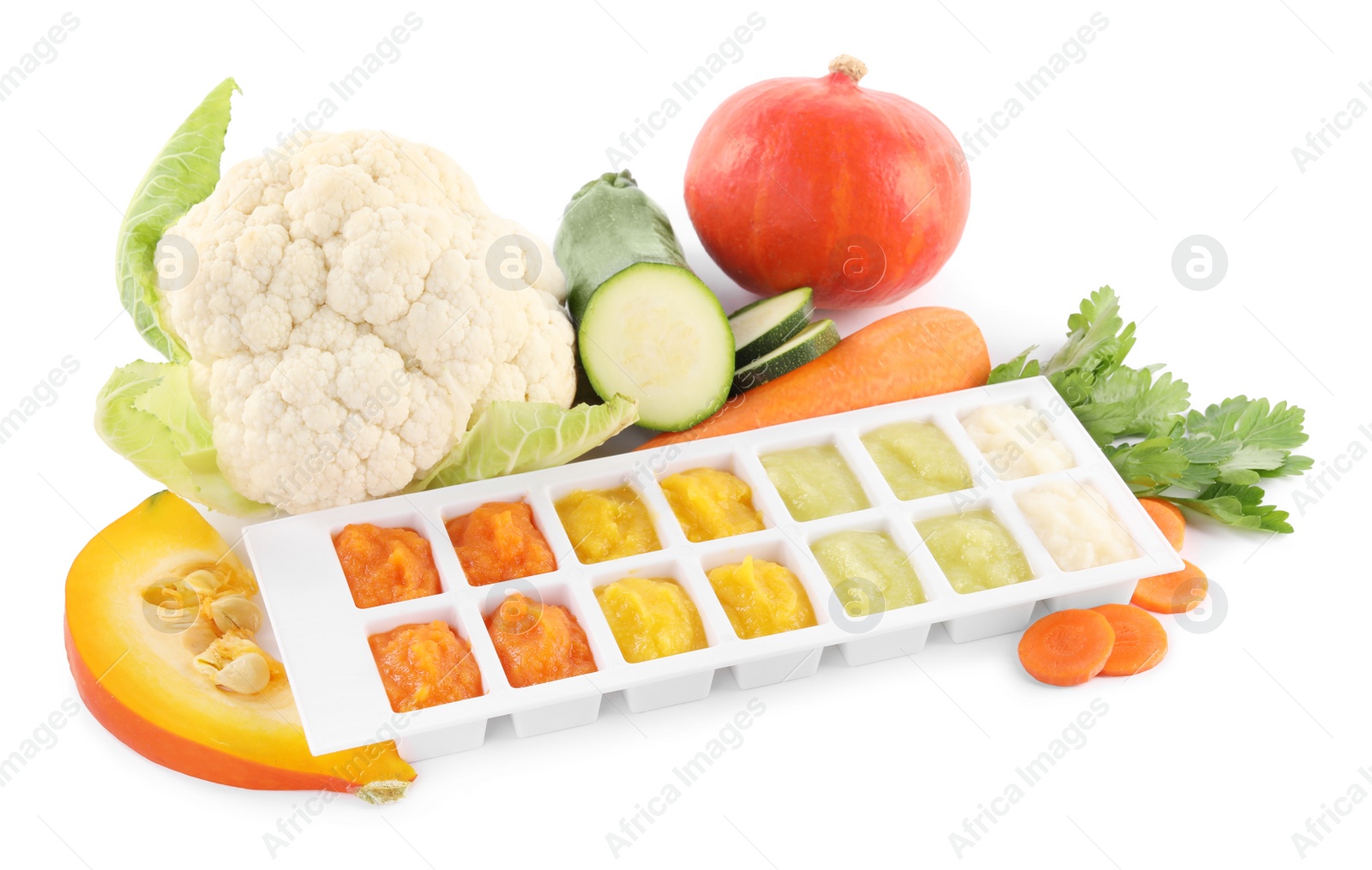 Photo of Different purees in ice cube tray and ingredients on white background. Ready for freezing