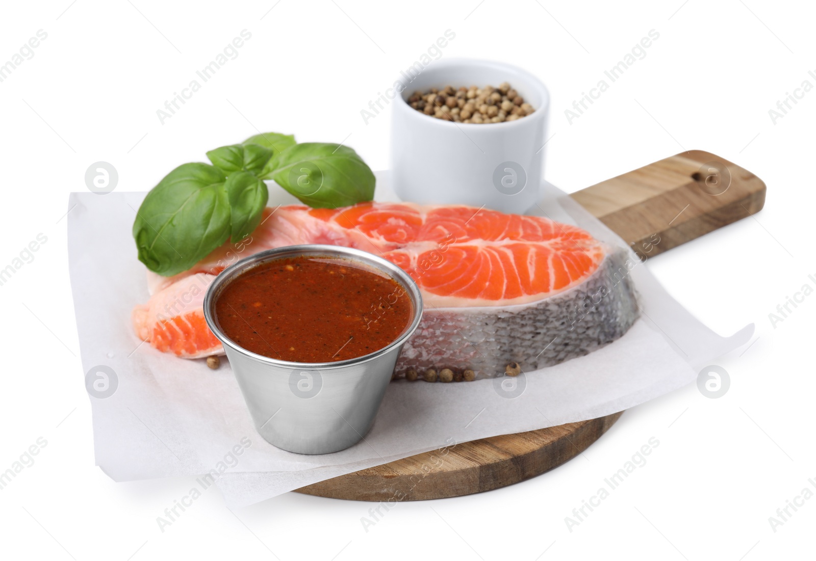 Photo of Fresh fish, basil, peppercorns and marinade isolated on white