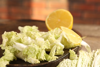 Photo of Fresh Chinese cabbage and lemon on table, closeup