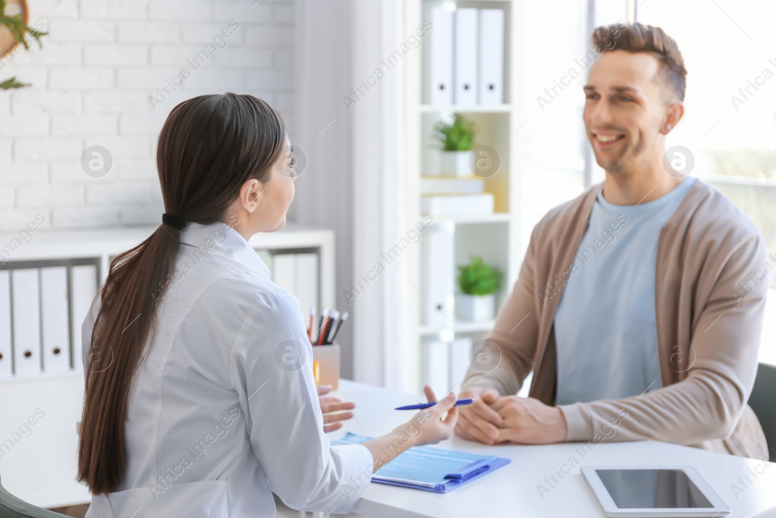 Photo of Female doctor consulting patient in clinic