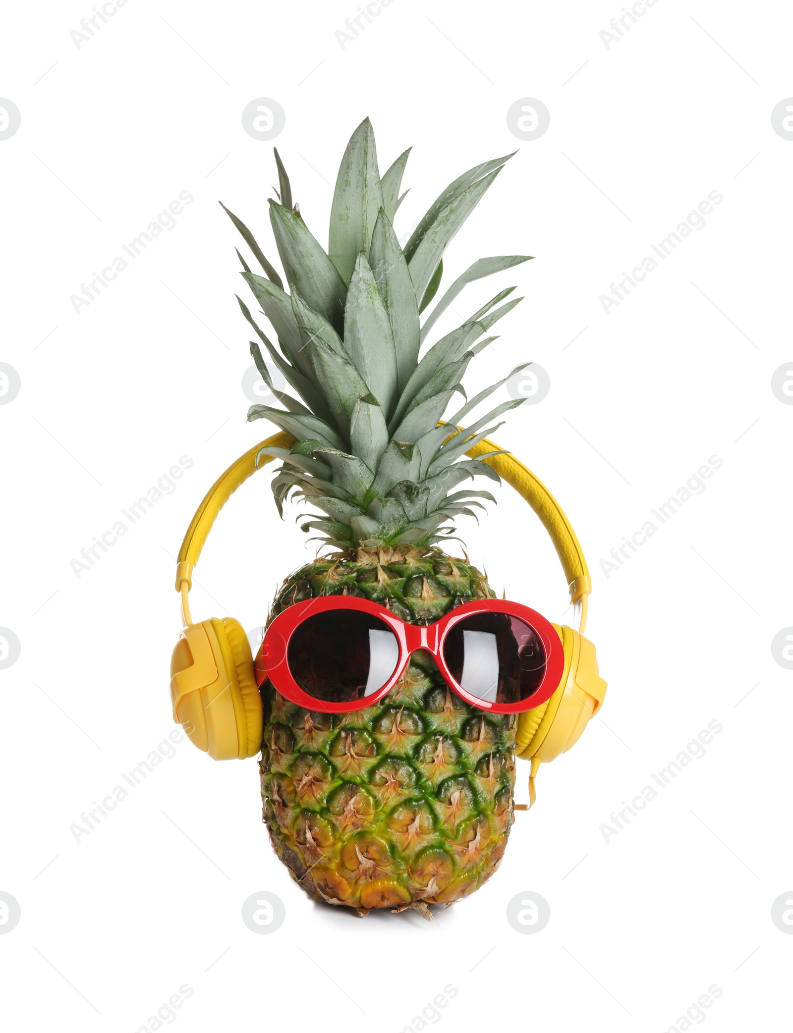 Photo of Funny pineapple with headphones and sunglasses on white background