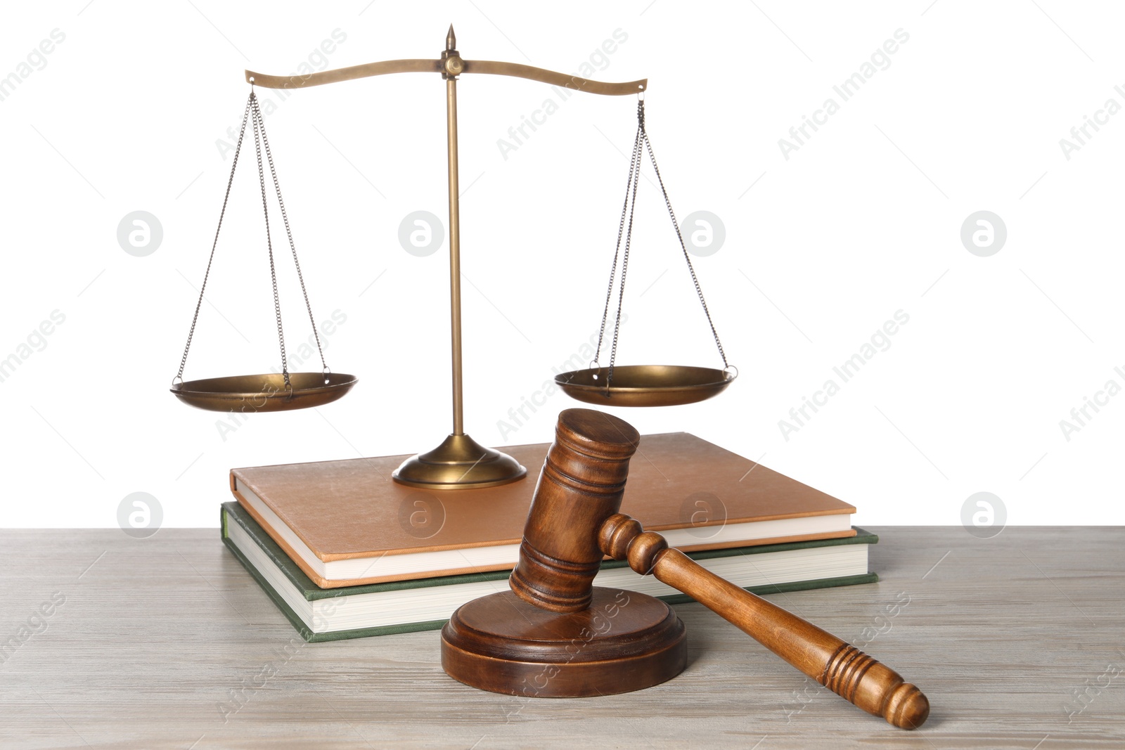 Photo of Law concept. Gavel, scales of justice and books on wooden table against white background