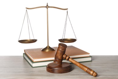 Photo of Law concept. Gavel, scales of justice and books on wooden table against white background