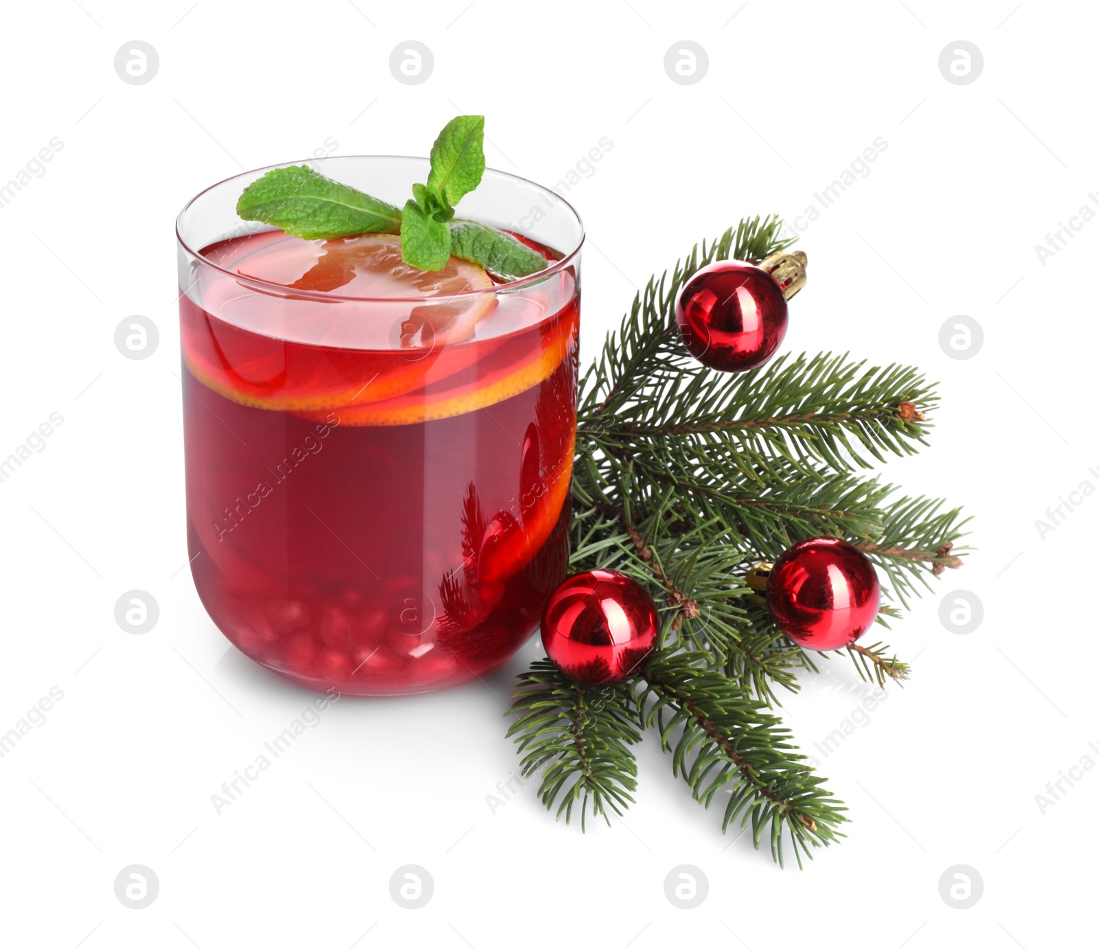 Photo of Christmas Sangria drink in glass, fir branch and baubles on white background