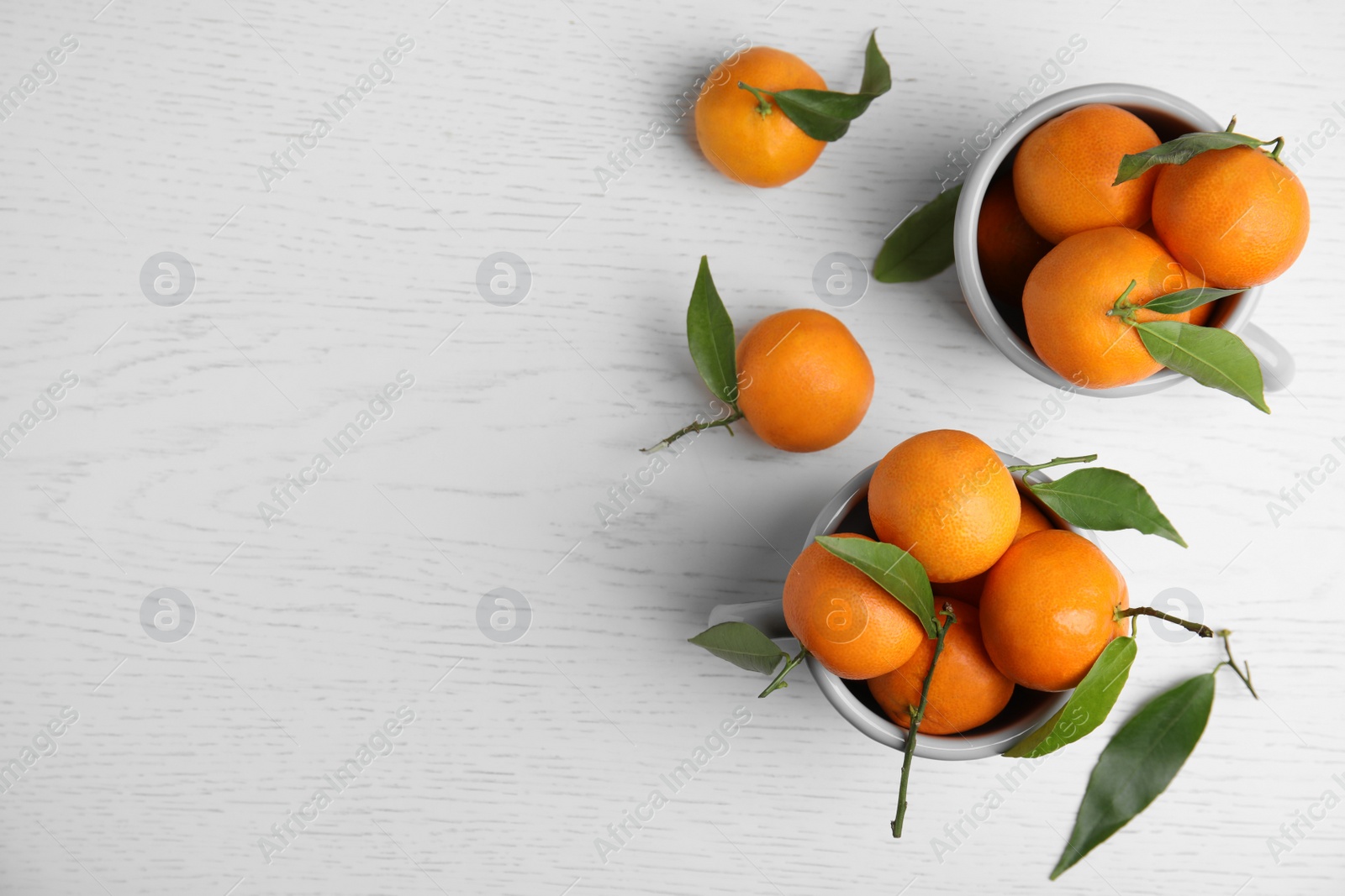 Photo of Flat lay composition with fresh ripe tangerines and space for text on wooden background