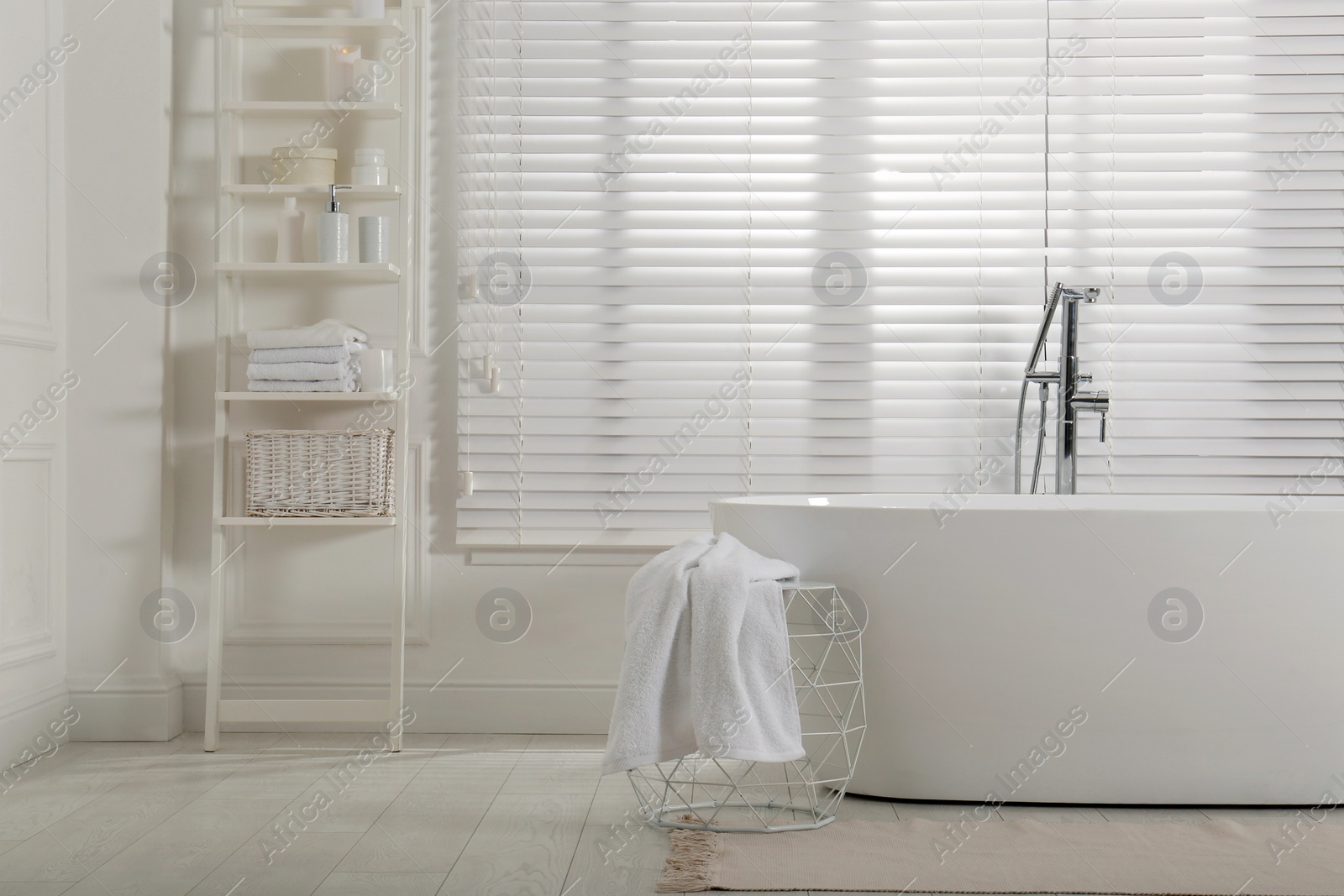 Photo of Minimal bathroom interior with modern white tub