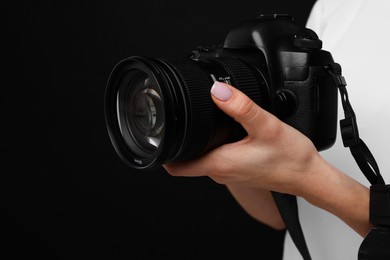 Photo of Photographer with camera on black background, closeup