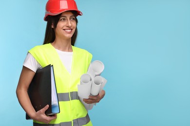 Architect in hard hat with drafts and folder on light blue background, space for text