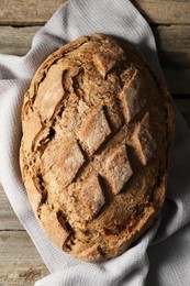 Photo of Freshly baked sourdough bread on wooden table, top view