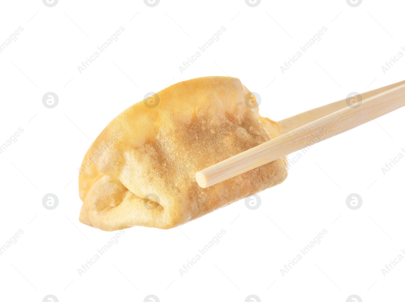 Photo of Chopsticks with delicious gyoza (asian dumpling) isolated on white